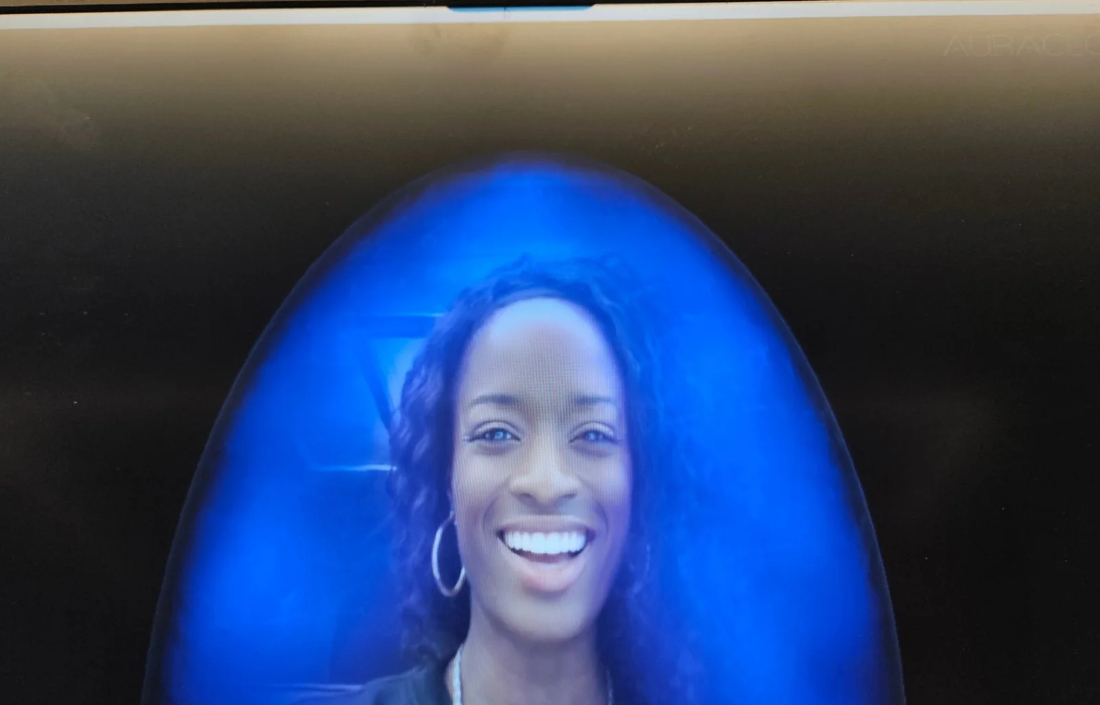 Guest's aura photograph shown on screen at an aura photography and tea pairing experience