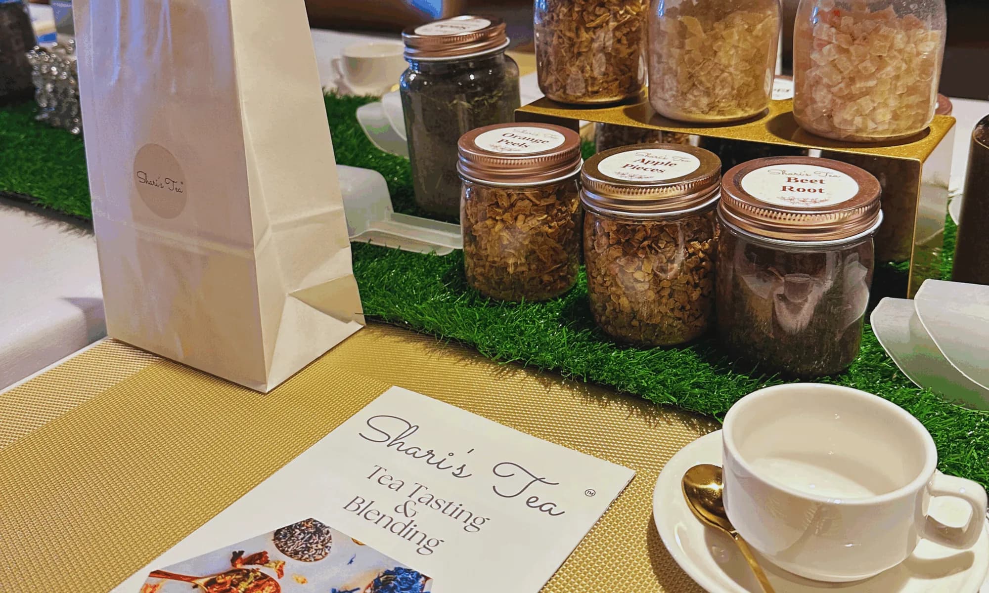 Branded Events by ST tea-blending station with jars of loose-leaf teas, herbs and a tasting card