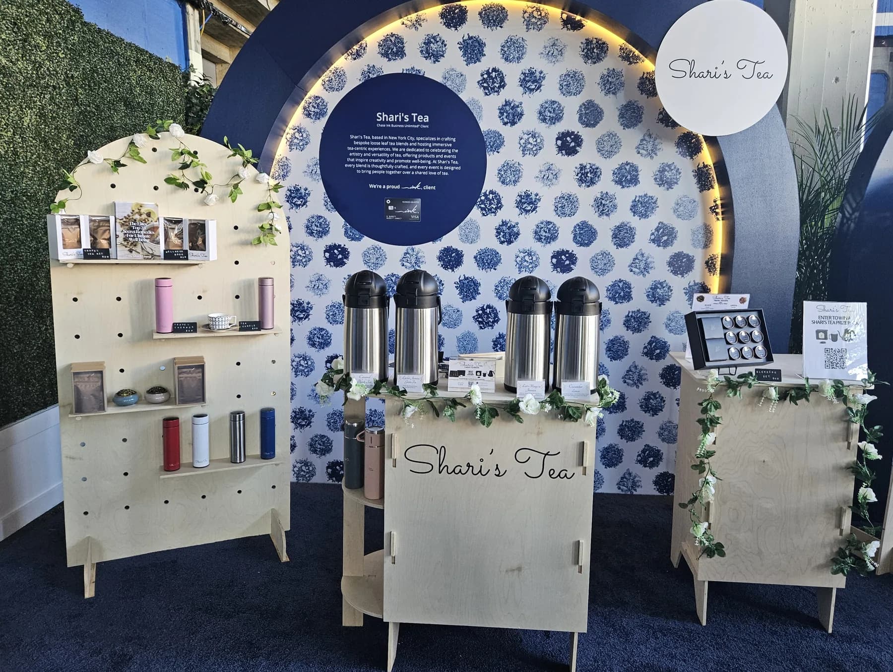 Custom Shari's Tea blending booth with branded blue-and-white backdrop at a Chase brand activation