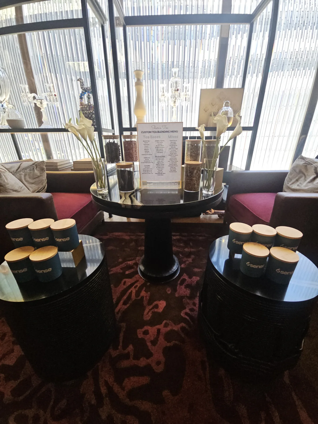 Elegant lounge tea-blending setup with custom tins and a blending menu at a corporate activation
